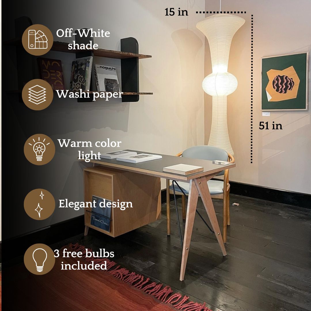 Large rice paper floor lamp with off-white washi paper shade, standing next to a minimalist wooden desk. Japanese-style paper lantern lamp with warm color light, elegant design for cozy workspace decor. Includes three free bulbs, 51 inches tall.